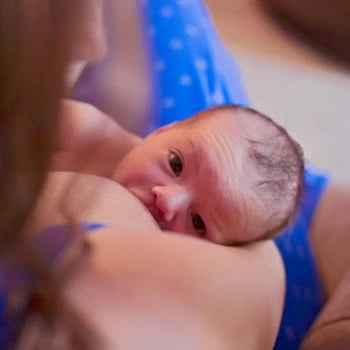 Healthy baby breastfeeding for first time 