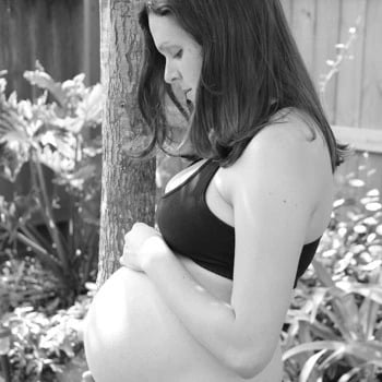 Woman holding belly like she is talking to her baby